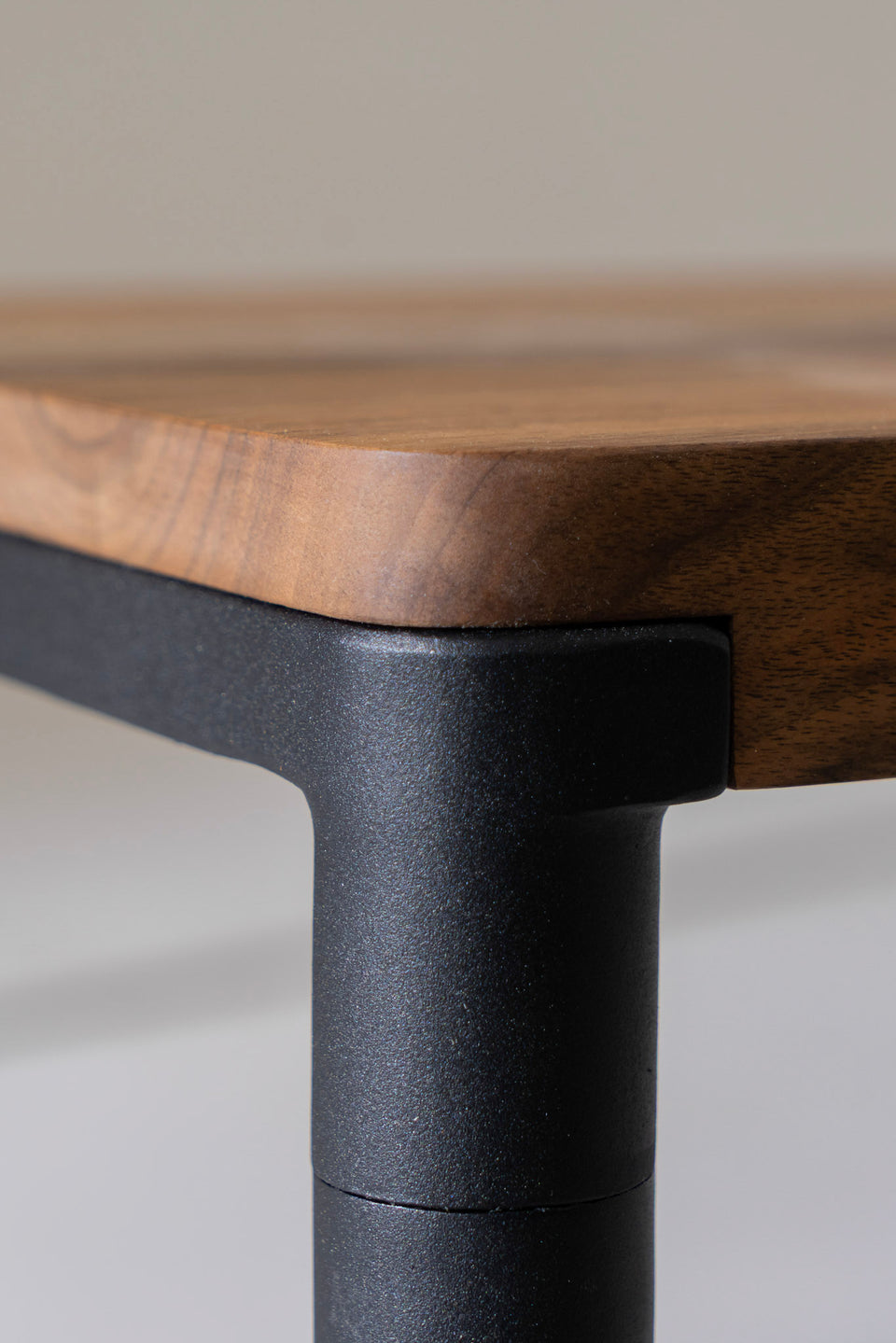 Steel legs integrated into solid wood top.